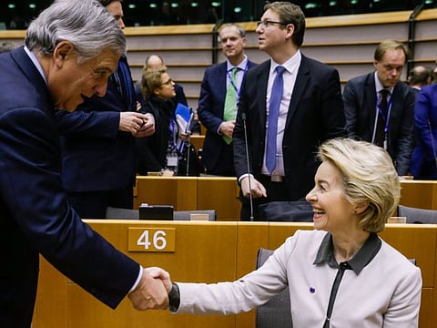 European Commission president Ursula von der Leyen (R) is greeted by former President of the European Parliament Antonio Tajani, before unveiling the Commission's broad orientations of 'Green New Deal' plan to fight climate change before the European Parliament in Brussels on December 11, 2019.