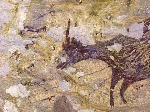A photo provided by Ratno Sardi shows, the hunting scene depicts characters wielding thin objects that may represent ropes or spears. Indonesian cave paintings may be oldest imaginative art by humans, are at least 43,900 years old and depict humanoid figures with animal-like features in a hunting scene.