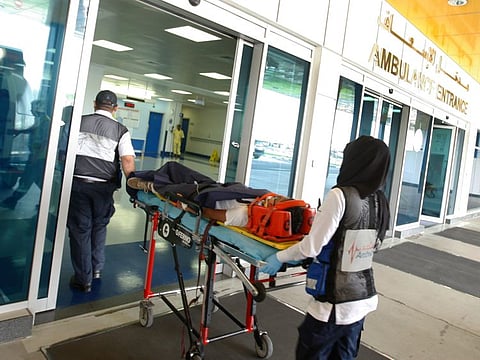 Paramedics transfer an injured patient from the ambulance to the Rashid Hospital