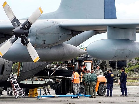 Military personnel unload from a Chilean Air Force plane, the landing gear of the C-130 Hercules transport plane which crashed in the sea on its way to Antarctica late Monday with 38 people on board, after its was recovered by search teams, in Punta Arenas, southern Chile, on December 13, 2019. Chile confirmed Thursday that a military which headed to the Eduardo Frei base across the Drake Passage in the Antarctic crashed in the sea, with no hope of finding survivors.