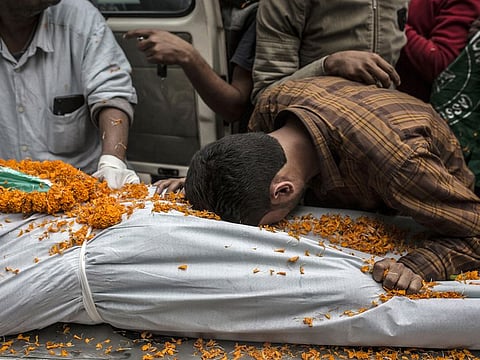 A man grieves over the body of his brother, who was shot by police last week and later died, in Guwahati, India, Dec. 15, 2019. Indian Muslims, who have watched anxiously as Prime Minister Narendra Modi’s government has pursued a Hindu nationalist program, have finally reacted with days of protests and clashes in response to a sweeping new citizenship law that favors every South Asian faith other than Islam