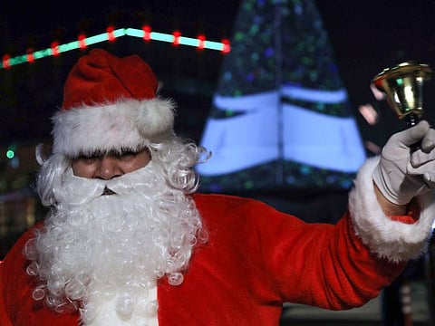 A man dressed as Santa Claus rings a bell at a Christmas market in Arbil, the capital of the autonomous Kurdish region of northern Iraq, on December 15, 2019