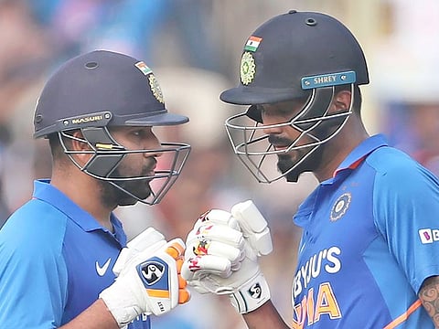 India's Rohit Sharma, left, interacts with batting partner KL Rahul after hitting a boundary during the second one day international cricket match against West Indies in Visakhapatnam, on Wednesday, December 18, 2019.