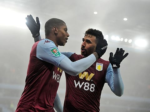 Aston Villa's Wesley, left, celebrates with Aston Villa's Mahmoud Ibrahim Hassan after scoring his side's fifth goal during the English League Cup quarter-final against Liverpool.