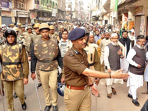 Police personnel patrol march during a protest against the Citizenship Amendment Act, in Varanasi on Friday.