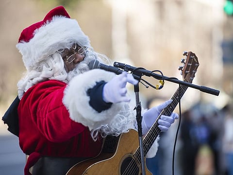 Antonio “Tony” Covay, who advertised himself on Craigslist as “Singing Black Santa,” performs last week outside the Smithsonian National Museum of Natural History. MUST CREDIT: Photo by Amanda Voisard for The Washington Post.