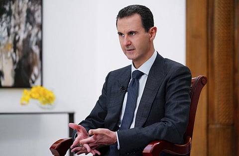 In this photo released on Monday Nov. 9, 2019 by the Syrian official news agency SANA, Syrian President Bashar Assad speaks during an interview with Italy's Rai News 24, in Damascus, Syria. Assad said in an interview aired Monday that the global chemical weapons watchdog has faked and falsified a report over an attack near the capital Damascus last year "just because the Americans wanted them to do so."