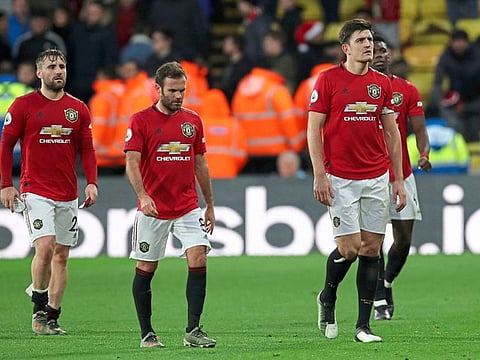 Manchester United players leave the field after the 2-0 loss to Watford.