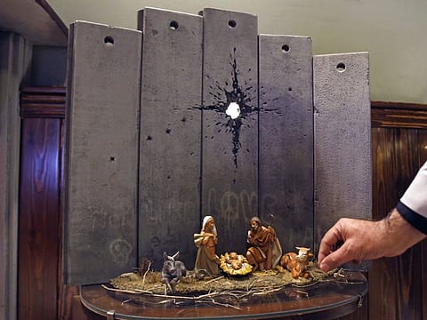 A new artwork dubbed "Scar of Bethlehem" by street artist Banksy is displayed at his Walled-Off Hotel in the occupied West Bank town of Bethlehem on December 21, 2019.