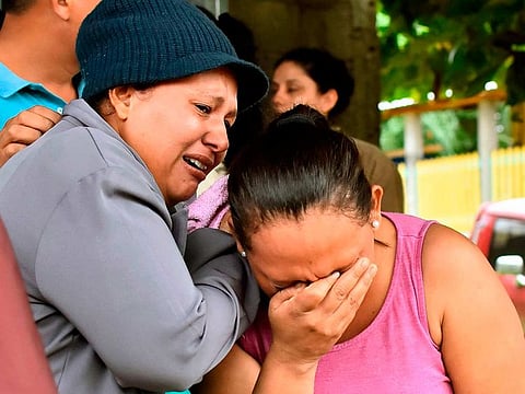 Relatives of inmates react after getting information about their loved ones in front of the penitentiary of Tela, Atlantida department, Honduras, on December 21, 2019, following clashes ocurred at the jail.