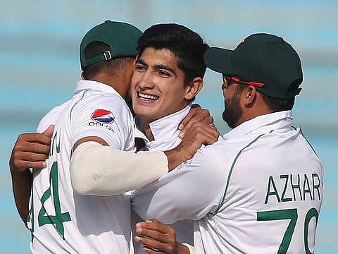 Pakistani captain Azhar Ali and teammate greet young bowler Naseem Shah, center, for taking wicket of Sri Lankan batsman during the Test in Karachi, Pakistan, Monday, December 23, 2019.