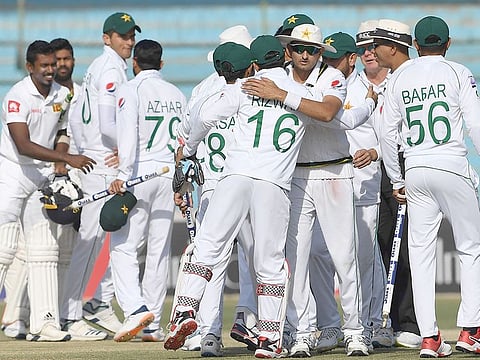 Pakistan players celebrate after winning the second Test cricket match against Sri Lanka at the National Cricket Stadium in Karachi on December 23, 2019.