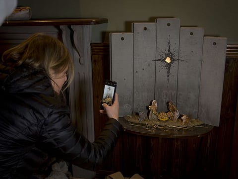 A new artwork dubbed "Scar of Bethlehem" by the artist Banksy displayed in The Walled Off Hotel, in the West Bank city of Bethlehem on December 22, 2019.