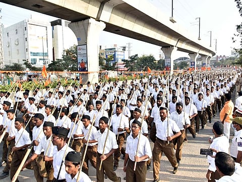 RSS members take part in a 'route march' toward the indoor stadium at Saroornagar in Hyderabad on Wednesday.