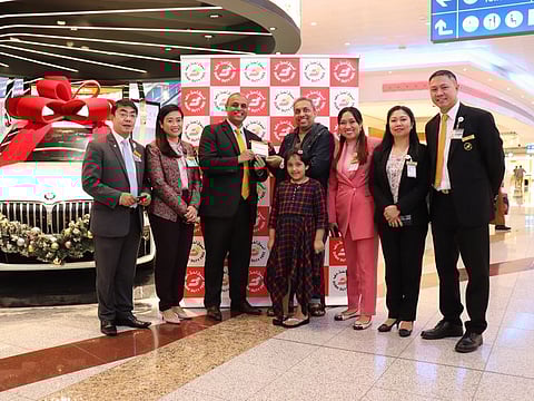 To celebrate the US$2 billion sales mark, Mr Sati and his daughter were presented with DDF gift cards worth US$2,000 by Dubai Duty Free officials in Concourse D.