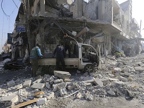 People gather in the the market in the city of Saraqeb in the Idlib countryside after an air strike by Syrian aircraft on December 21, 2019. Airstrikes on a rebel-held town killed several people