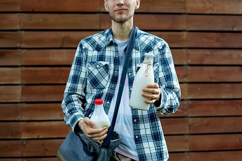 The milkman made his rounds around the colony with a can of milk strapped to the back carrier of his bicycle