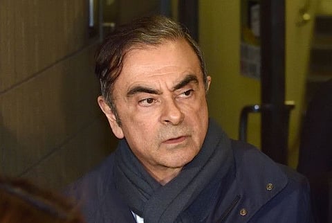 (FILES) This file photo taken on April 3, 2019 shows former Nissan Chairman Carlos Ghosn leaving the office of his lawyer Junichiro Hironaka in Tokyo.