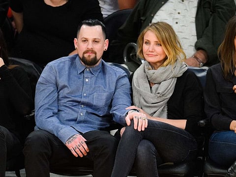 Benji Madden (L) and Cameron Diaz attend a basketball game between the Washington Wizards and the Los Angeles Lakers at Staples Center in Los Angeles, California. AFP filles