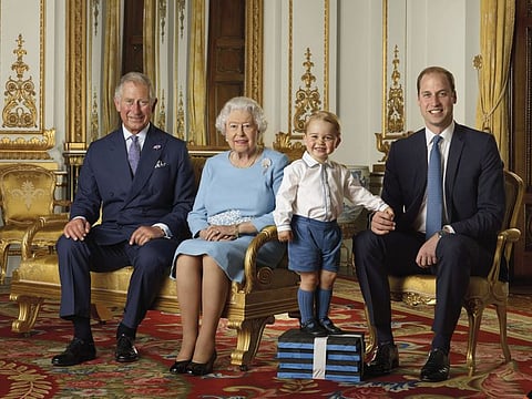 FILE - In this file handout photo provided by Buckingham Palace and released in 2016, Britain's Queen Elizabeth, Prince Charles, Prince William and Prince George pose for a photo to mark the Queen's 90th birthday, in the White Drawing Room at Buckingham Palace, London. Buckingham Palace have released a photo of the Queen and the next three in line to the throne to mark the new year. This is only the second time such a portrait has been released, the first was in April 2016 to celebrate Her Majesty's 90th birthday. (Ranald Mackechnie/Buckingham Palace via AP)