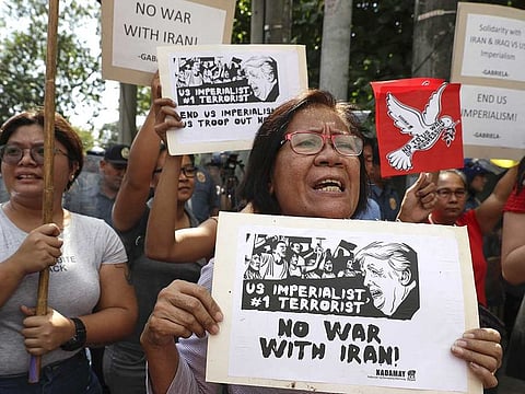 Protesters hold slogans during a rally opposing the recent U.S. attack that killed Iranian Gen. Qasem Soleimani in Manila, Philippines
