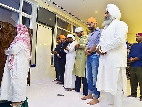 Sikhs and Muslims pray together at the Gurunanak Darbar Sikh Temple in Dubai after Iftar on the first day of Ramadan