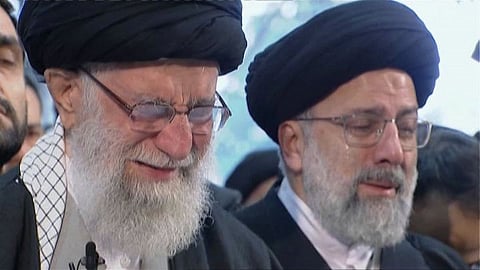In this image taken from video, Iranian Supreme Leader Ayatollah Ali Khamenei, left, openly weeps as he leads a prayer over the coffin of Gen. Qassem Soleimani, who was killed in Iraq in a U.S. drone strike on Friday, at the Tehran University campus, in Tehran, Iran, Monday, Jan. 6, 2020.
