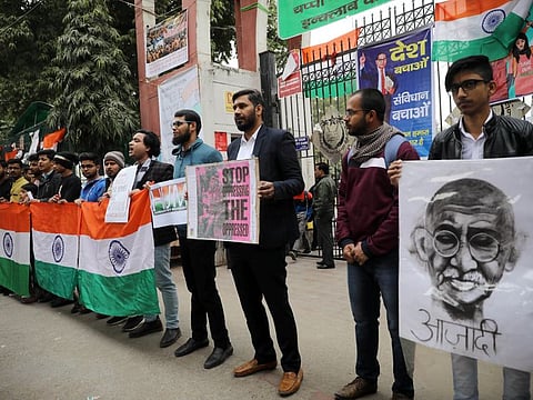 Demonstrators hold placards and shout anti-government slogans during a protest against the attack on JNU Students outside Jamia Millia Islamia, in New Delhi on Sunday.