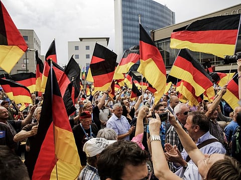 Supporters waving flags during the inaugural AfD election rally during Brandenburg state elections