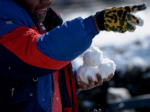 A man gets ready to throw snowballs. For illustrative purposes only
