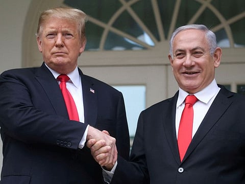 US President Donald Trump shakes hands with Israel's Prime Minister Benjamin Netanyahu as they pose on the West Wing colonnade in the Rose Garden at the White House in Washington, last year