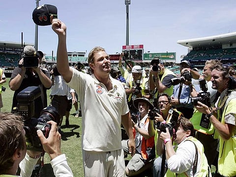 Australian bowler Shane Warne waves his cap to the crowd as he leaves the field following their win over of England in the fifth and final Ashes cricket test in Sydney, Australia. Warne's baggy green cap has made more than 1 million Australian dollars ($685,000) at auction to aid those affected by wild fires across the country.