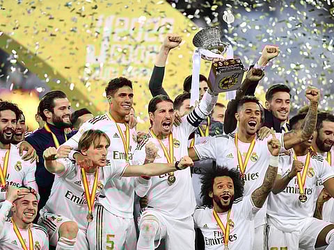 Sergio Ramos lifts the trophy as Real Madrid players celebrate winning the Super Cup.