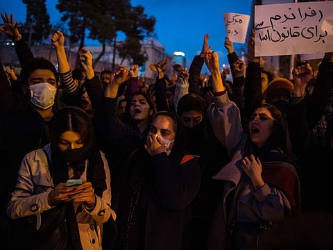 Demonstrators chant while gathering during a vigil for the victims of the Ukraine International Airlines flight that was unintentionally shot down by Iran, in Tehran, Iran, on Saturday, Jan. 11, 2019.