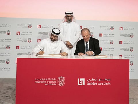 Sheikh Khalid bin Mohamed bin Zayed oversees Mohamed Al Mubarak and Roger Brown of Berklee signing the deal. WAM