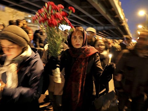 People gather for a candlelight vigil to remember the victims of the Ukraine plane crash, at the gate of Amri Kabir University that some of the victims of the crash were former students of, in Tehran.