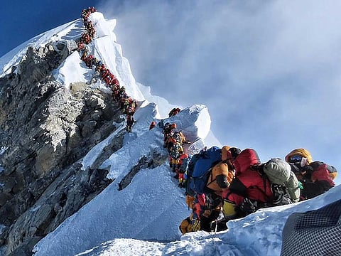 A long queue of climbers make their way up to the summit of the Everest.