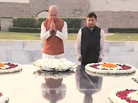 Jeff Bezos, founder and CEO of Amazon and the world's top billionaire, seen wearing Indian traditional attire — white kurta and an orange half-jacket — as he pays his respects to the Mahatma Gandhi.