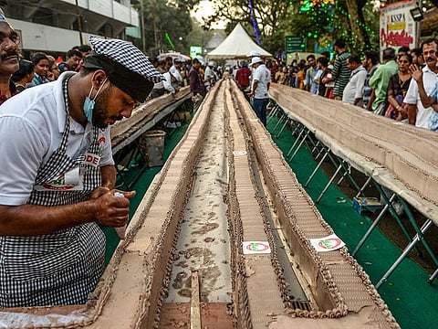 A baker prepares an approximatively 6.5-km long cake as a attempt aim to break the Guinness World Record for the longest cake, in Thrissur in south Indian state of Kerala on January 15, 2020.