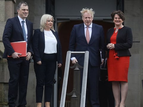 Britain's Prime Minister Boris Johnson poses for photographs with Deputy first minister Michelle O'Neill of Sinn Fein, First Minister Arlene Foster of the DUP and Northern Ireland Secretary of State, Julian Smith, as the power sharing government prepares to sit for the first time in three years in Belfast, Northern Ireland January 13, 2020.