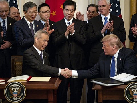 US President Donald Trump and China's Vice-Premier Liu He shake hands after signing a limited trade agreement at the White House on January 15, 2020.
