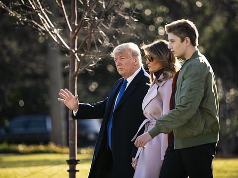 U.S. President Donald Trump, First Lady Melania Trump, and son Barron Trump walk to board Marine One on the South Lawn of the White House in Washington, D.C., on Friday. Trump has named constitutional lawyer Alan Dershowitz to present arguments for his acquittal in his Senate impeachment trial.