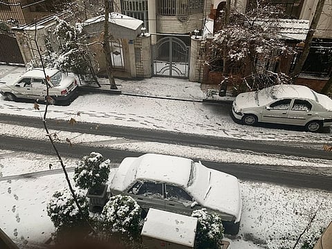 Snow blankets Tehran street.