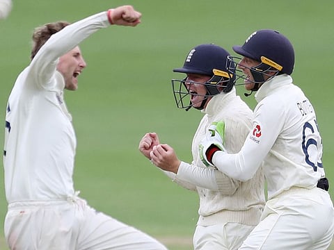 England's Ollie Pope (centre) celebrates taking the catch to dismiss South Africa's Rassie van der Dussen off the bowling of Joe Root (left).