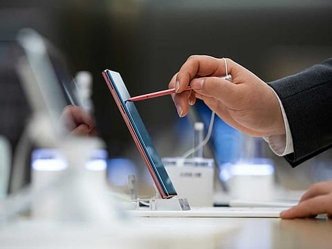 An employees inspects a Samsung Electronics Co. Galaxy Note 10+ 5G smartphone at the company's Digital Plaza store in Seoul, South Korea.