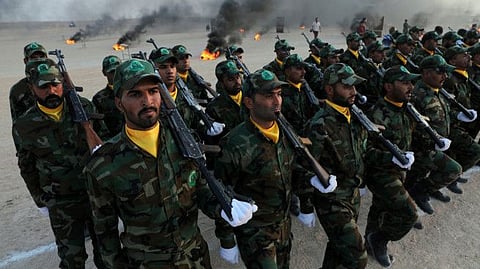 Members of the paramilitary Popular Mobilisation Forces (PMF) take part in their graduation ceremony at a military camp in Kerbala, Iraq