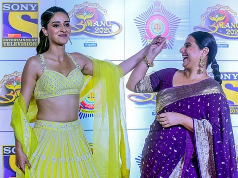 In this picture taken on January 19, 2020, Bollywood actress Ananya Pandey (L) and Vidya Balan (R) pose for photographs as they arrive to attend the annual 'Umang Mumbai Police Show' in Mumbai. / AFP / Sujit Jaiswal