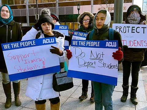 Protesters stand outside the federal courthouse where a hearing was scheduled for Northeastern University student Shahab Dehghani, Tuesday, Jan. 21, 2020, in Boston.