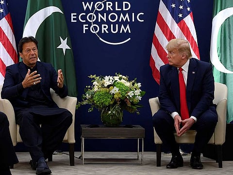 US President Donald Trump (R) speaks with Pakistani Prime Minister Imran Khan ahead of their meeting at the World Economic Forum in Davos, on January 21, 2020.