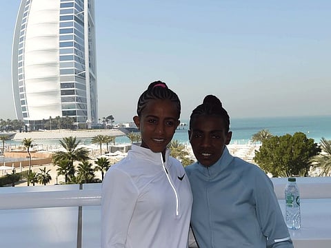 Worknesh Degefa and Buzunesh Deba, two of the leading women runners, pose at the media conference with the iconic Burj Al Arab at the backdrop.